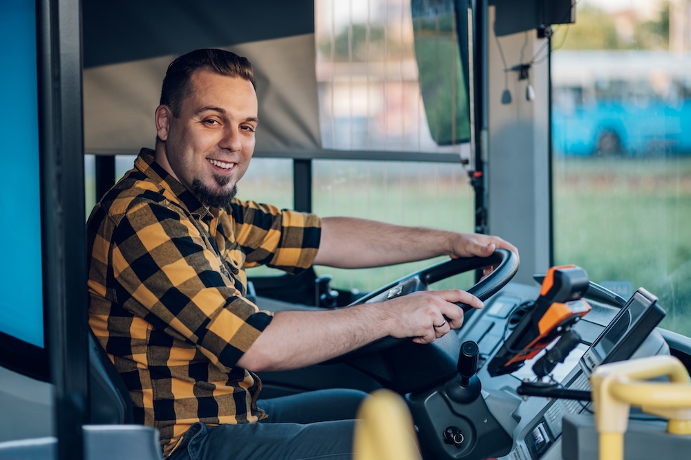 Bus driver behind the wheel of a public transport vehicle