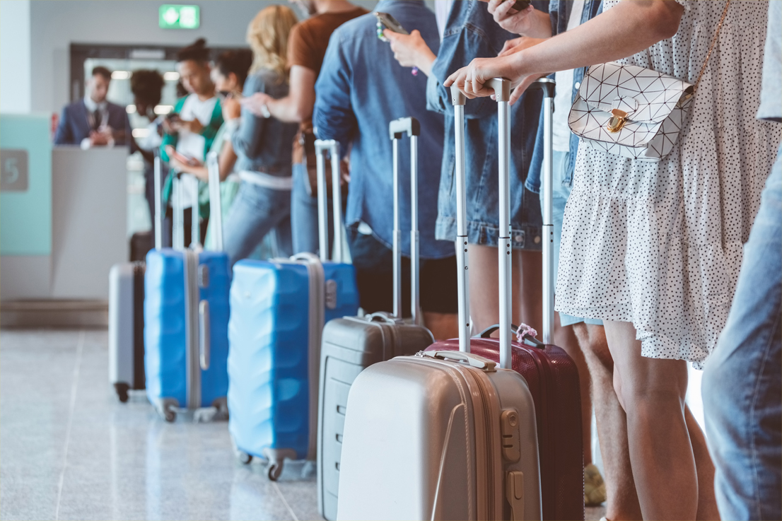 luggage of people in line at the airport