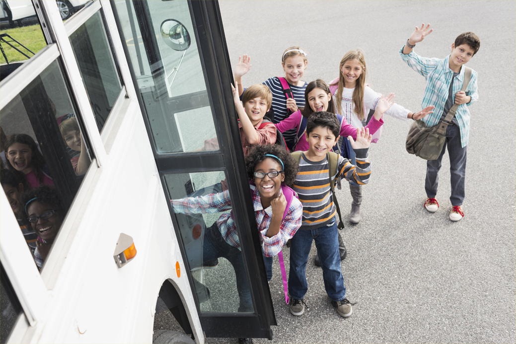 kids standing outside bus