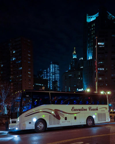 Executive Coach bus at night.