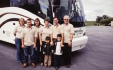 people in front of a coach bus