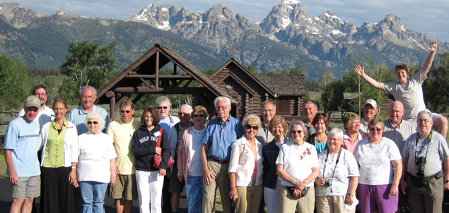 group of tour partners in front of the mountains.