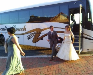 Bride and groom exiting a coach bus