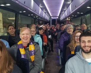 People smiling on a coach bus